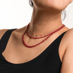 Model showcasing the Love Ruby Faceted Dainty Necklace, highlighting its vibrant red hues and elegant design.