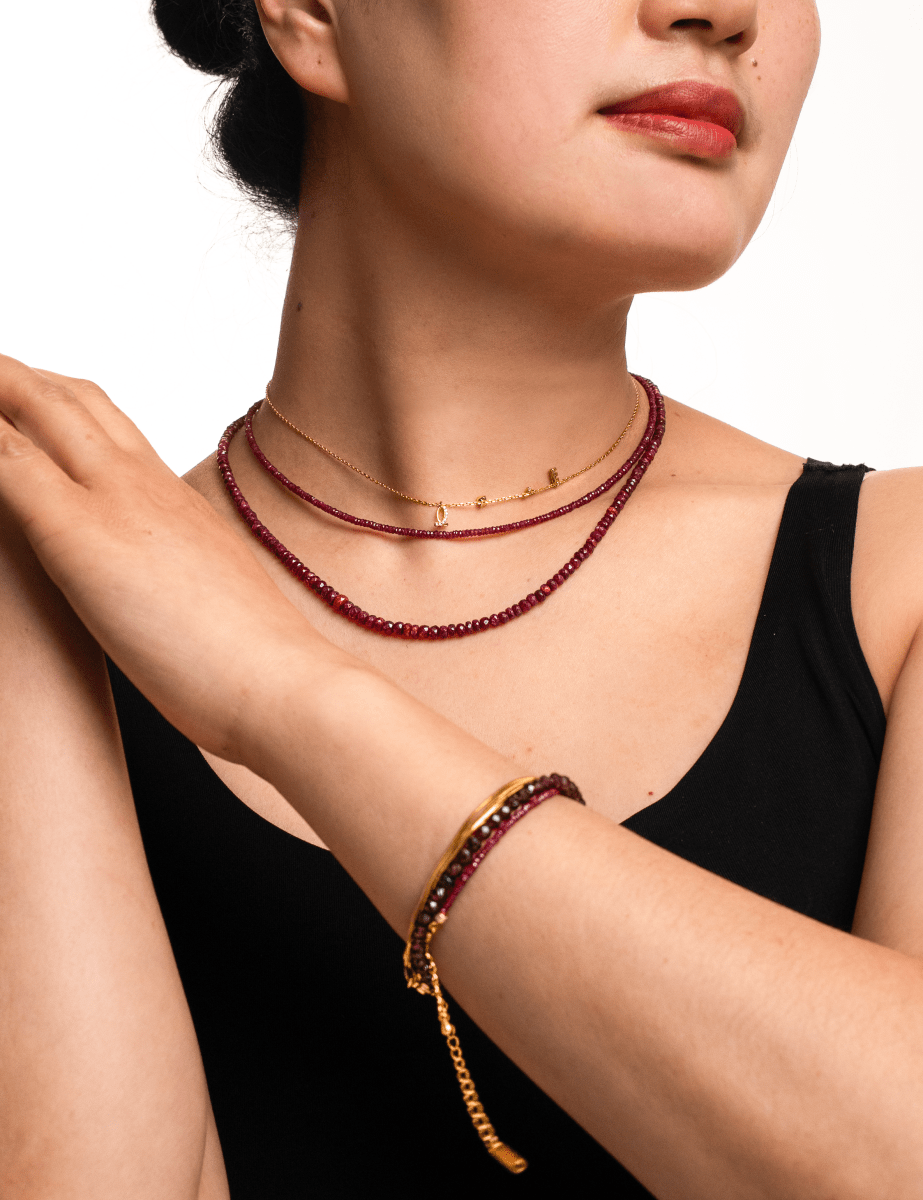 Model showcasing Love Ruby Faceted Dainty Necklace and bracelet, radiating warmth and elegance.