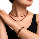 Model showcasing Love Ruby Faceted Dainty Necklace and bracelet, radiating warmth and elegance.