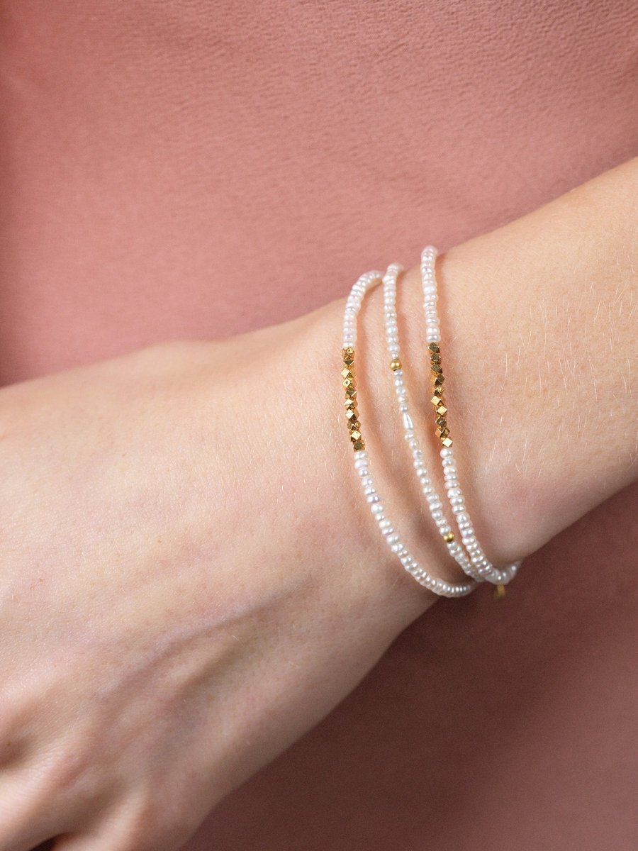 Metal Lunar Essence Pearl Dainty Bracelet with silver spacer beads on a woman's wrist.