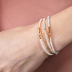 Metal Lunar Essence Pearl Dainty Bracelet with silver spacer beads on a woman's wrist.