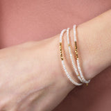 Metal Lunar Essence Pearl Dainty Bracelet with silver spacer beads on a woman's wrist.