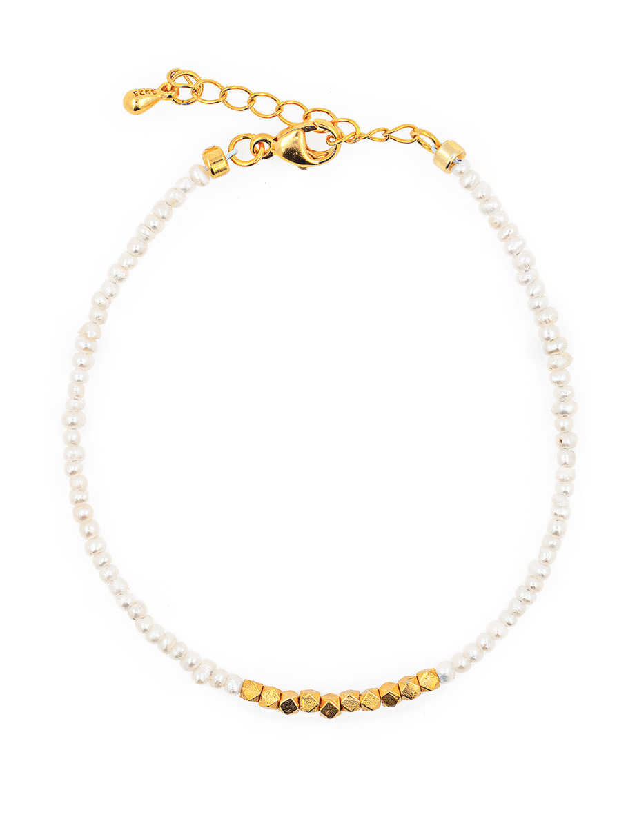 Dainty pearl bracelet with silver spacer beads, showcasing elegance and natural beauty, perfect for refined styling.