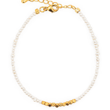 Dainty pearl bracelet with silver spacer beads, showcasing elegance and natural beauty, perfect for refined styling.