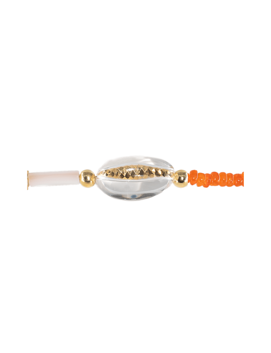 Close-up of a gold-plated mother of pearl and clear quartz choker necklace accent, showcasing elegant design details.