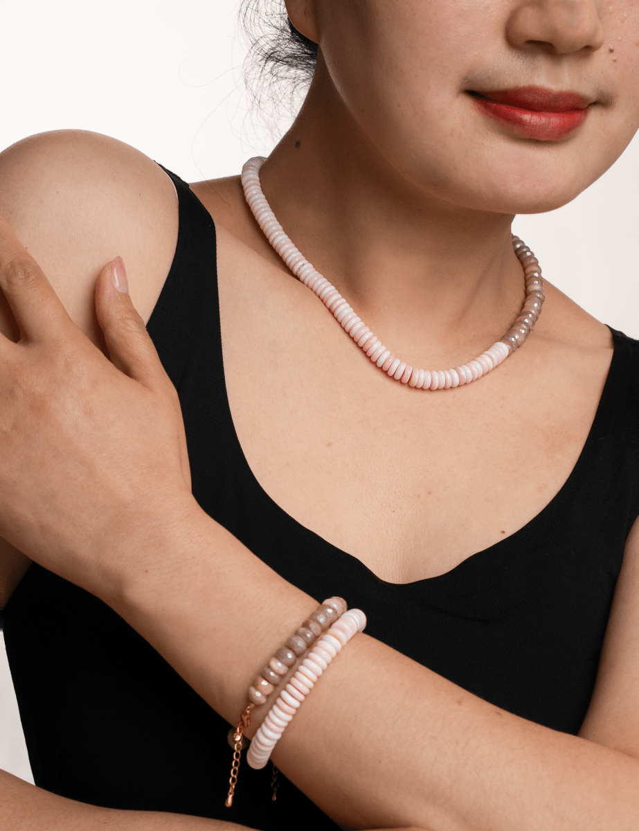 Model wearing New York Moonstone & Conch Shell faceted necklace and matching bracelet, showcasing serene oceanic elegance.