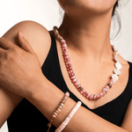 Model showcasing New York Pink Conch Shell 8mm faceted bracelet and pink beaded necklace.