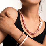 Model showcasing New York Pink Conch Shell 8mm faceted bracelet and pink beaded necklace.
