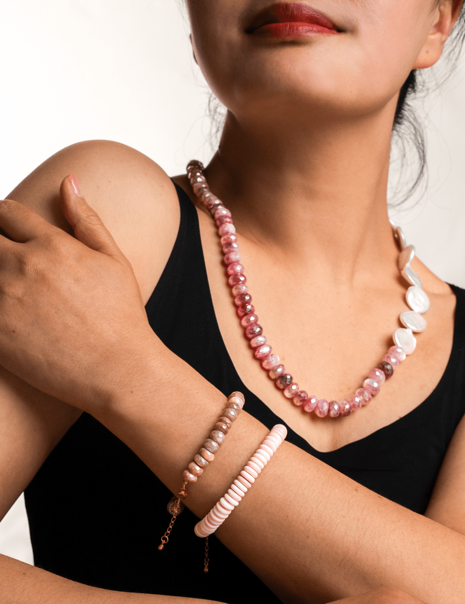 Model showcasing New York Pink Conch Shell 8mm faceted bracelet and pink beaded necklace.