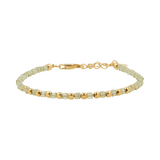 Dainty peridot bracelet with faceted beads and gold-plated sterling silver accents, perfect for layering.