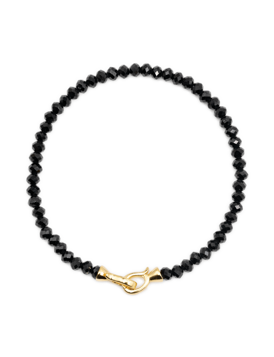 Black Onyx bracelet with 3x4mm faceted beads and a gold clasp, promoting protection and emotional balance.