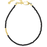 Black Tourmaline faceted bracelet with gold clasp and silver spacer, promoting protection and emotional stability.