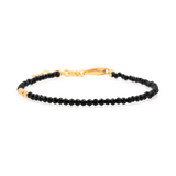 Black Tourmaline faceted dainty bracelet with silver spacer bead, promoting protection and emotional stability.