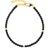 Dainty Black Tourmaline bracelet with gold spacer beads, featuring a secure clasp for elegant protection and grounding.