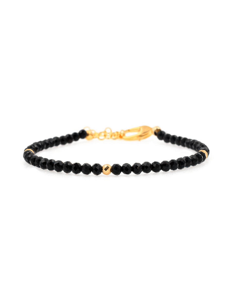 Black Tourmaline dainty bracelet with gold clasp, featuring protective gemstones and elegant design.