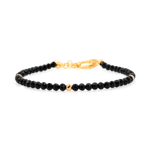 Black Tourmaline dainty bracelet with gold clasp, featuring protective gemstones and elegant design.