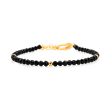 Black Tourmaline dainty bracelet with gold clasp, featuring protective gemstones and elegant design.