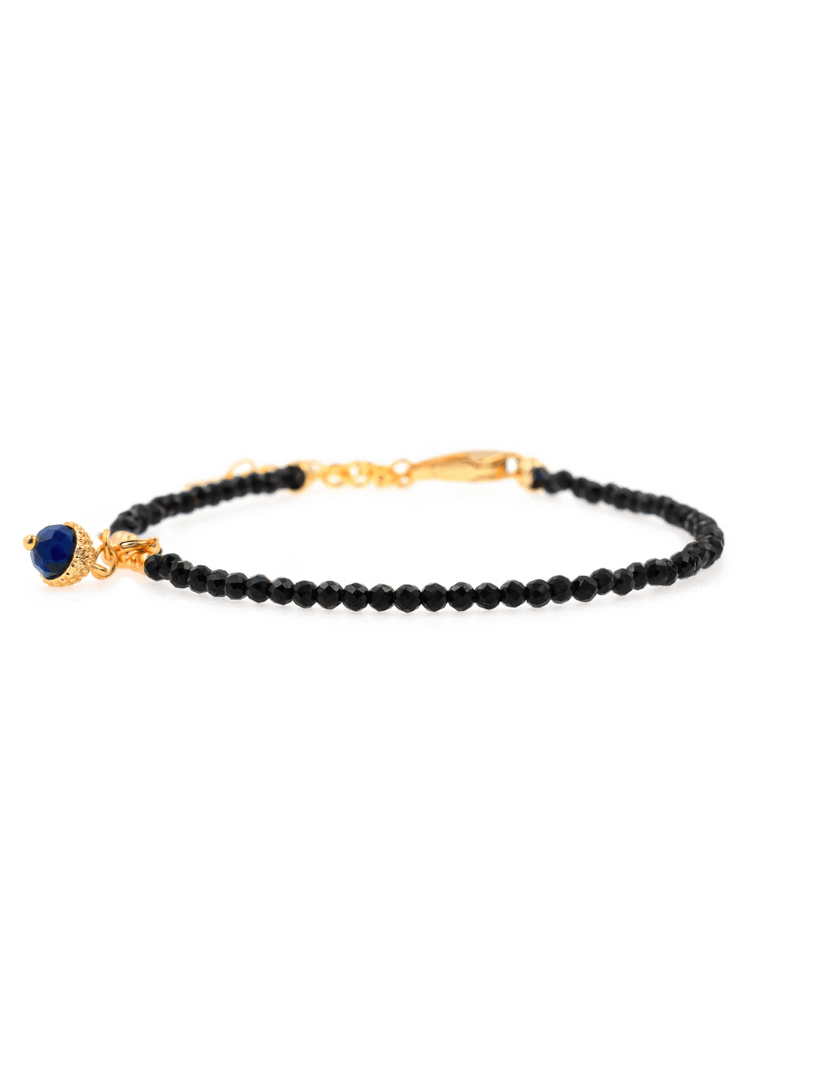 Black Tourmaline faceted bracelet with silver spacer and Lapis Lazuli charm for protection and elegance.