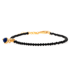 Black Tourmaline faceted bracelet with silver spacer and Lapis Lazuli charm for protection and elegance.