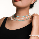 Model showcasing layered necklaces and a bracelet, highlighting unique design and elegant style.