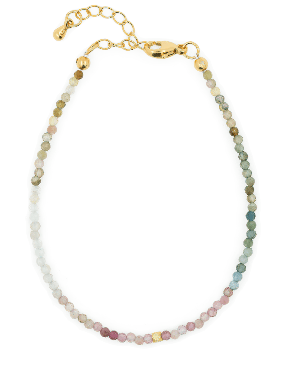 Dainty sterling silver bracelet featuring multicolored tourmaline beads and gold accents for protection and elegance.