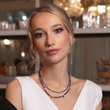 Model showcasing SHANGHAI sapphire and blue topaz drop pendant necklace in elegant setting.