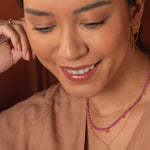 Woman modeling SHANGHAI Pink Sapphire & Citrine Drop Pendant Necklace in 18K Gold, showcasing its elegance.