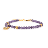Amethyst dainty bracelet with gold spacer beads and heart charm, symbolizing love and emotional balance.