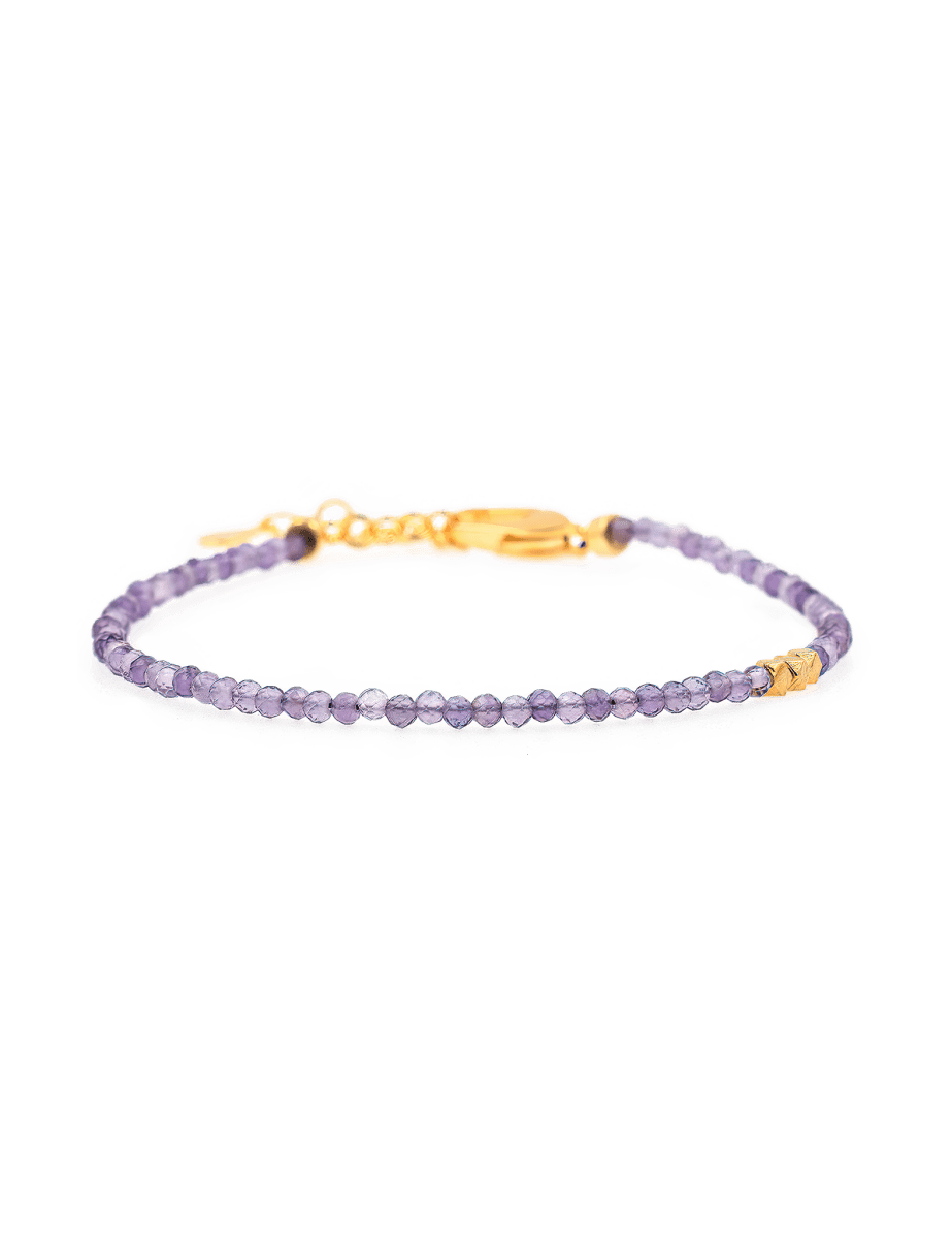 Dainty amethyst bracelet with gold clasp and spacer beads, promoting spiritual growth and inner wisdom.