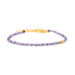 Dainty amethyst bracelet with gold clasp and spacer beads, promoting spiritual growth and inner wisdom.