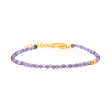 Dainty amethyst bracelet with gold clasp and spacer beads, promoting spiritual growth and inner wisdom.