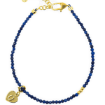 Lapis Lazuli faceted dainty bracelet with gold spacer bead and heart charm, perfect for spirituality and elegance.