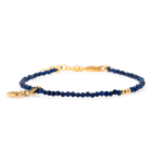 Lapis Lazuli faceted bracelet with gold spacer and heart charm, symbolizing love and spiritual insight.