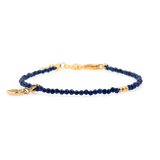 Lapis Lazuli faceted bracelet with gold spacer and heart charm, symbolizing love and spiritual insight.