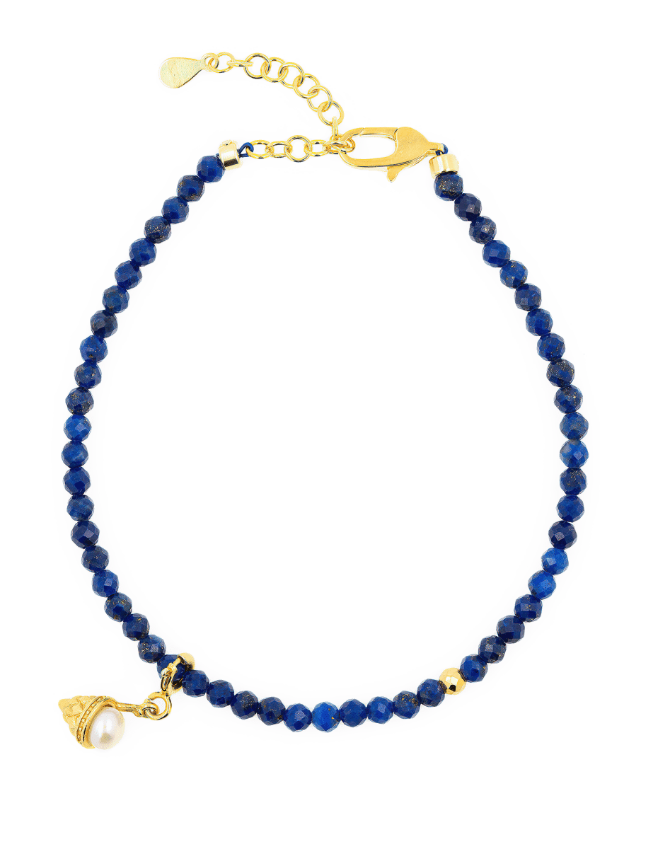 Lapis Lazuli faceted bracelet with gold clasp and pearl charm, symbolizing spirituality and playfulness.