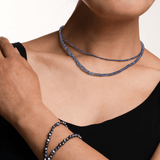 Woman wearing a stunning Tanzanite necklace, showcasing its spiritual energy and calming beauty.