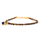Dainty yellow Tiger's Eye bracelet with silver spacer bead and Lapis Lazuli charm, perfect for confidence and wisdom.