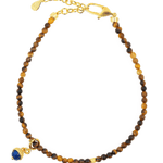 Dainty Yellow Tiger’s Eye bracelet with Lapis Lazuli charm and silver spacer bead, perfect for confidence and wisdom.