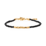 Black Tourmaline bracelet with gold spacer beads, promoting emotional balance and grounding.