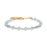 Dainty aquamarine faceted bracelet with gold clasp, symbolizing clarity and emotional balance.