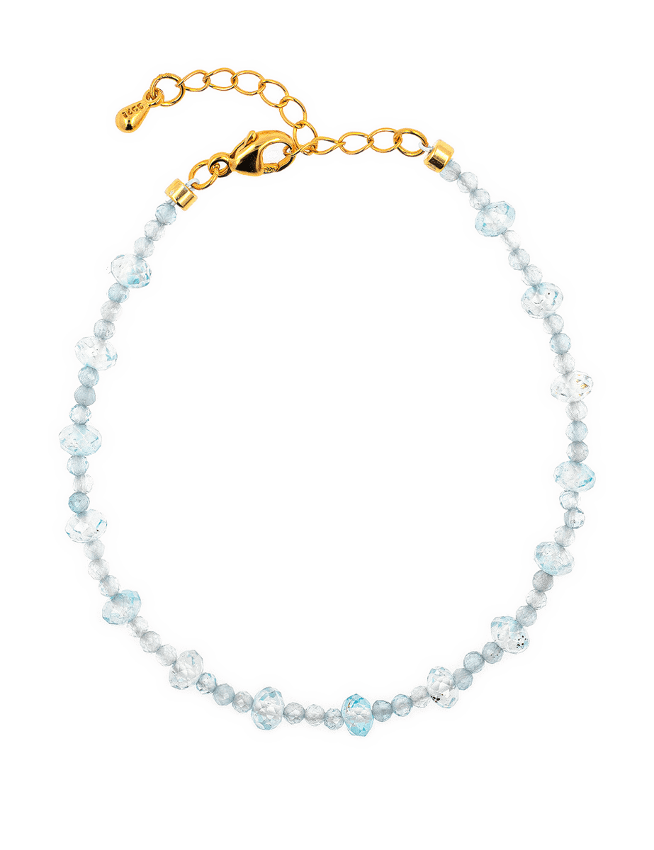 Dainty aquamarine bracelet with gold clasp, embodying clarity and emotional balance for modern lifestyles.