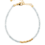 Dainty aquamarine bracelet with silver spacer beads, reflecting modern minimalist design and water element energy.