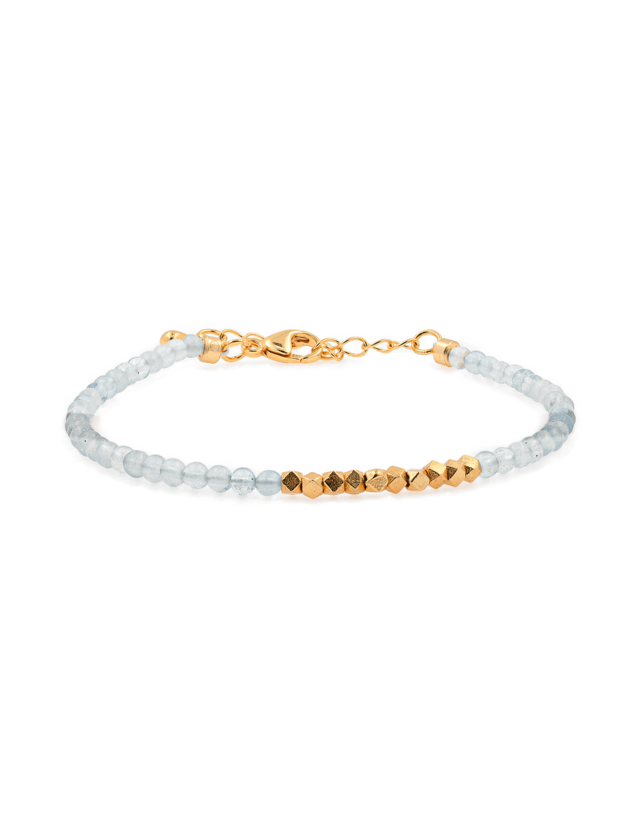 Dainty aquamarine bracelet with gold spacer beads, symbolizing clarity and resilience in modern design.