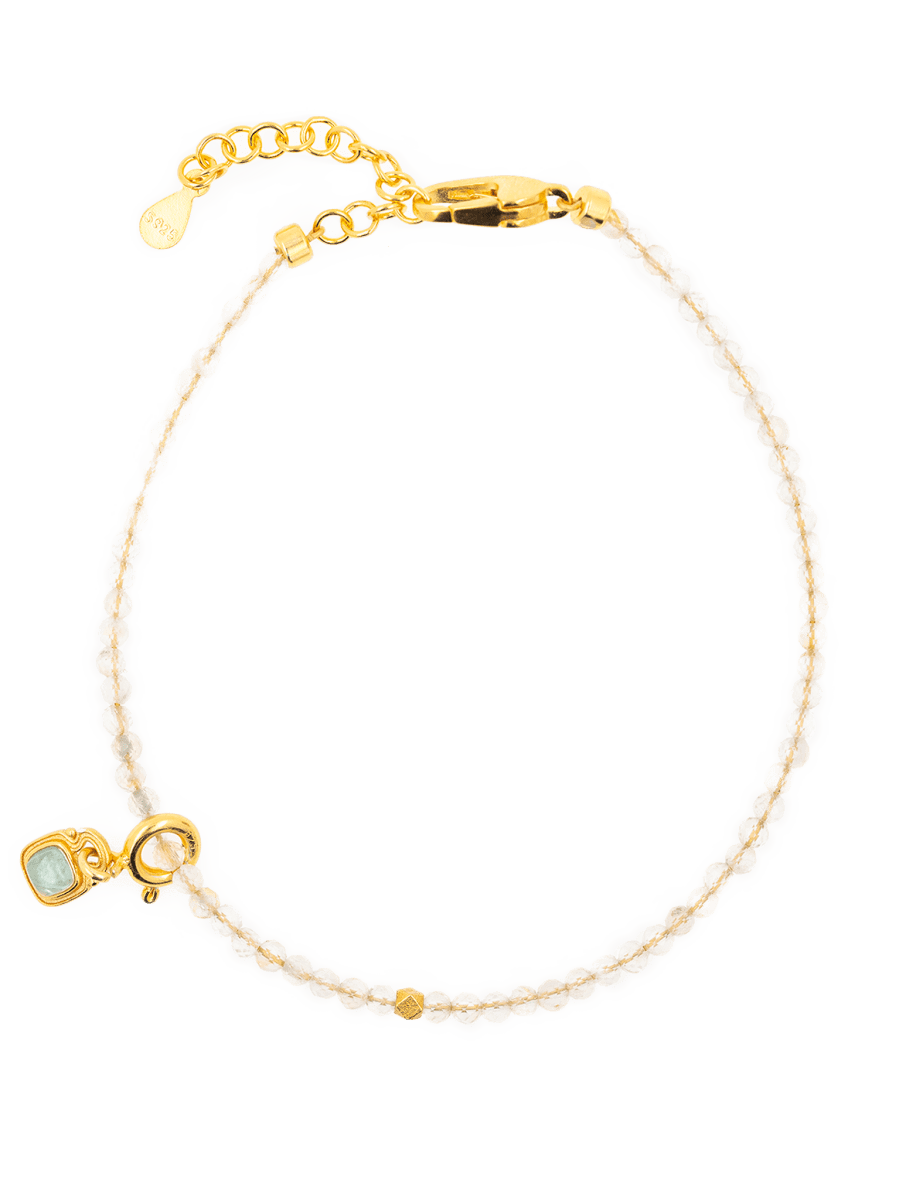 Wealth Citrine faceted dainty bracelet with tourmaline charm on a stylish background.