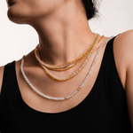 Woman wearing a layered Wealth Yellow Sapphire necklace, showcasing 4mm faceted beads that symbolize success and prosperity.