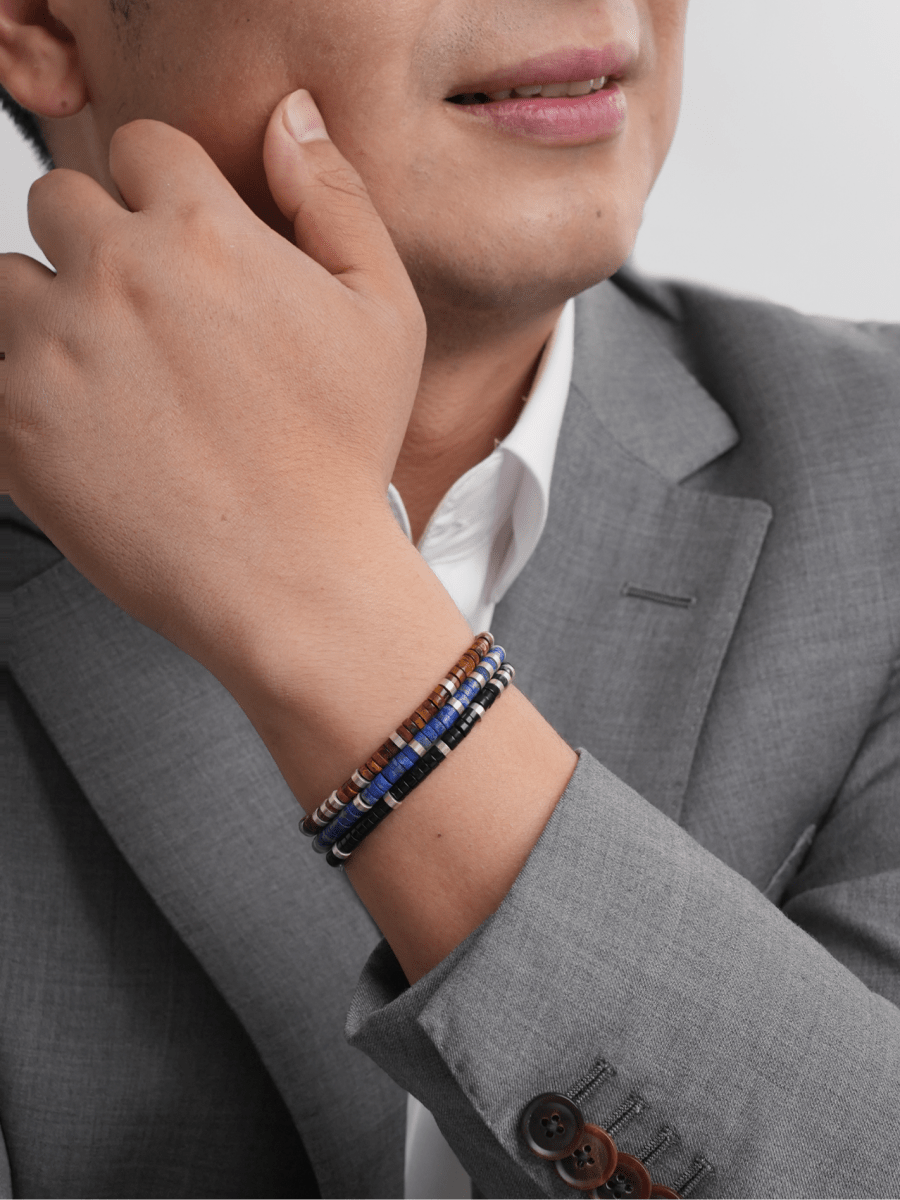 Man wearing a Lapis Lazuli and Sterling Silver faceted bracelet, showcasing elegance and style.