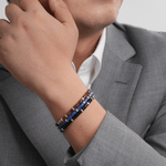 Man wearing a Lapis Lazuli and Sterling Silver faceted bracelet, showcasing elegance and style.