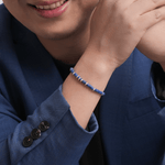 Man wearing Wisdom Lapis Lazuli & Sterling Silver Faceted Bracelet, showcasing its elegant design and vibrant blue beads.
